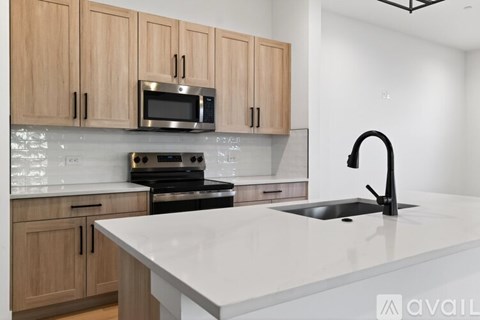 A modern kitchen with wooden cabinets and a white countertop.
