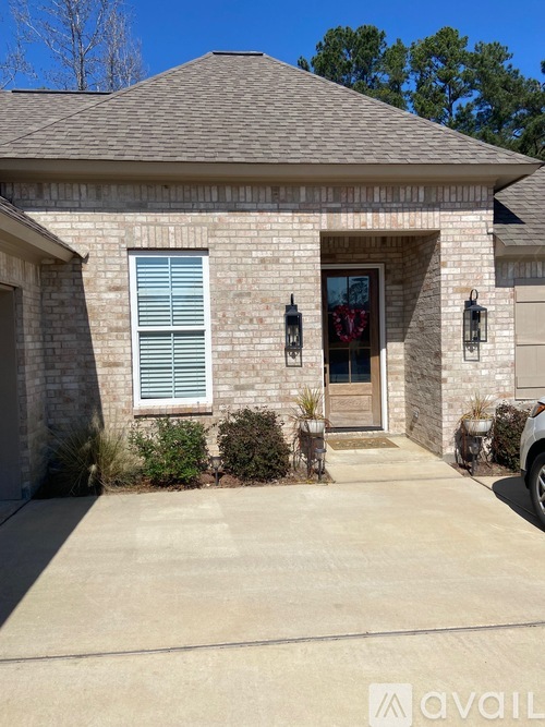 A house with a grey roof and a brown stone exterior.