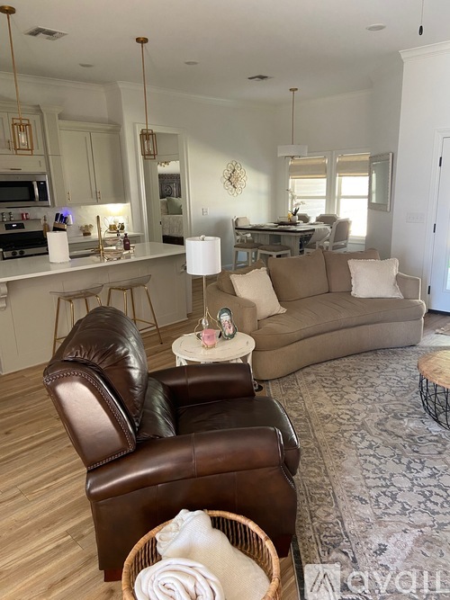 A living room with a brown leather chair and a white table.