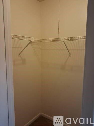 Empty white closet with two hangers.