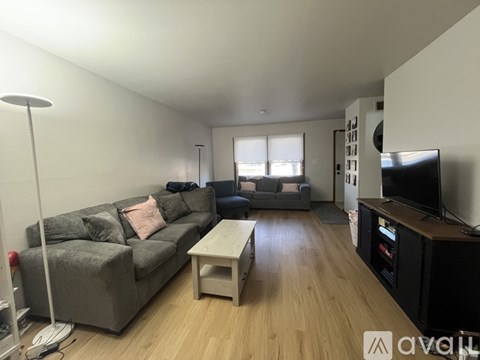 A living room with a grey couch and a white coffee table.