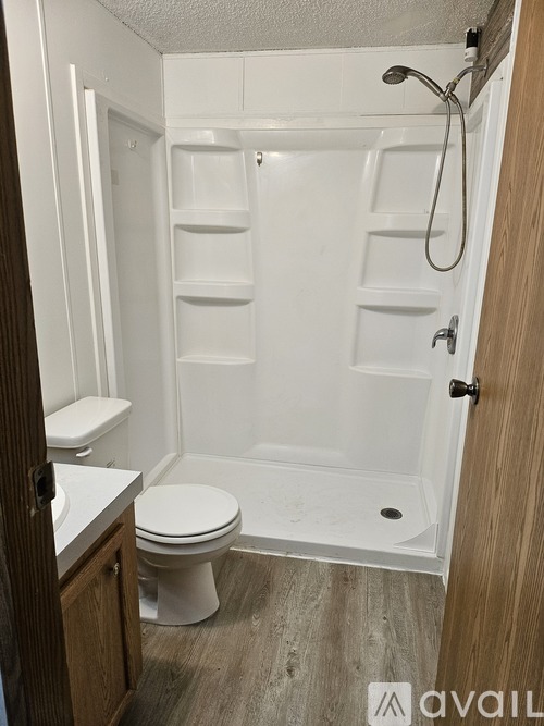A white toilet and sink in a small bathroom.