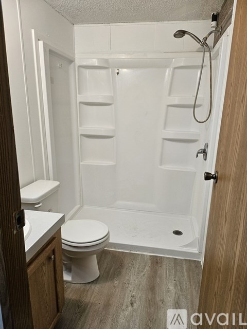 A white toilet and sink in a small bathroom.
