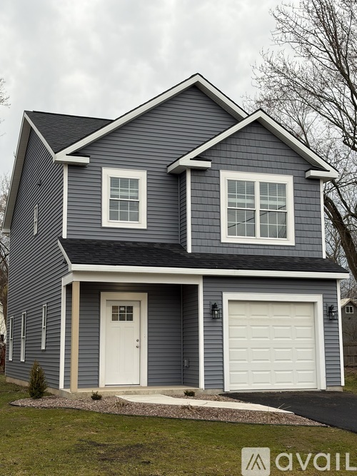 A two-story house with a garage and a white door.