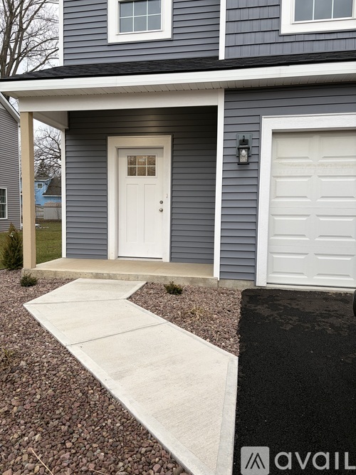 A house with a white door and a white garage door.
