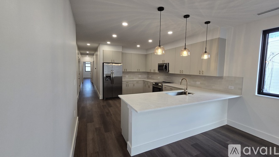 A modern kitchen with a long island in the middle.
