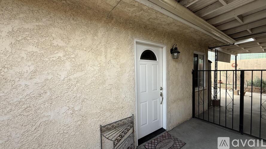 A white door with a black handle is on the left side of a gate.