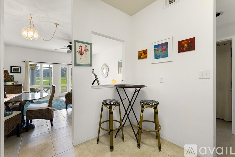 A dining area with a table and chairs.
