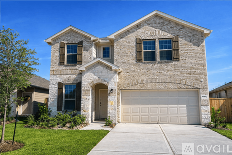 A house with a stone facade and a large garage door.