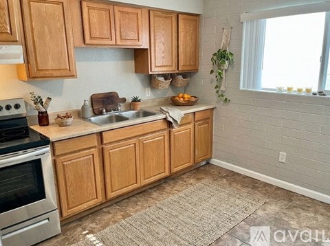 A kitchen with wooden cabinets and a stove top oven.