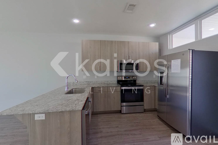 A modern kitchen with wooden cabinets and stainless steel appliances.