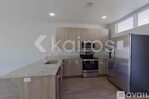 A modern kitchen with wooden cabinets and stainless steel appliances.