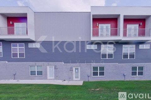 A modern apartment building with balconies and doors.