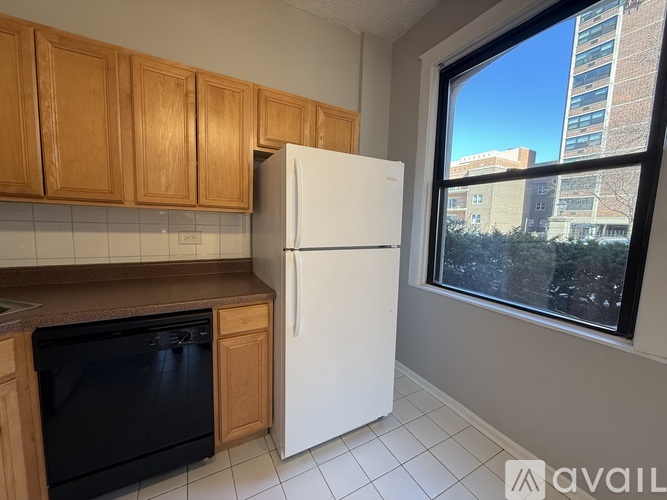 A kitchen with wooden cabinets and a white refrigerator.