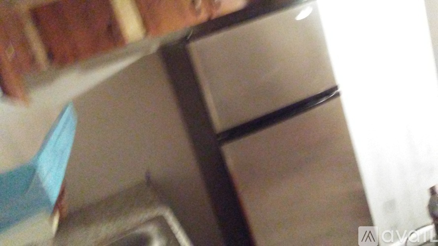 A person is standing in front of a refrigerator.