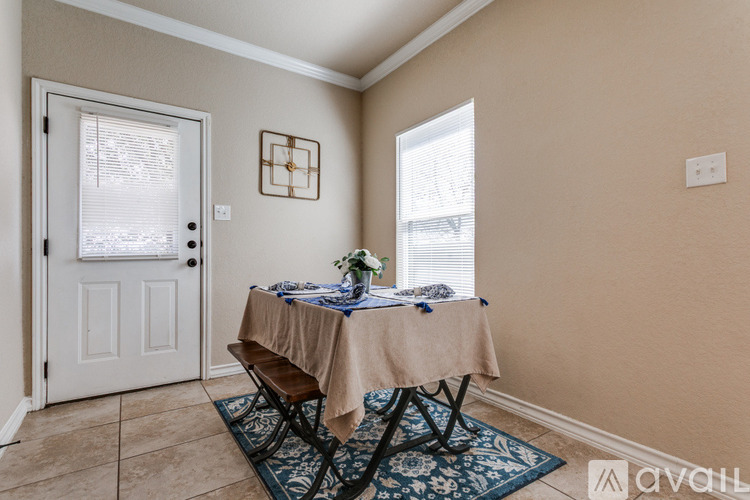 A dining area with a table set for two.