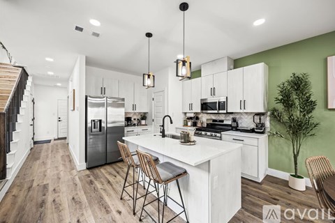 A modern kitchen with white cabinets and a center island.