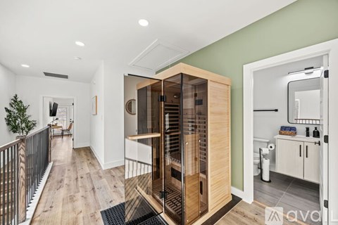 A modern kitchen with a wooden cabinet and a glass door.