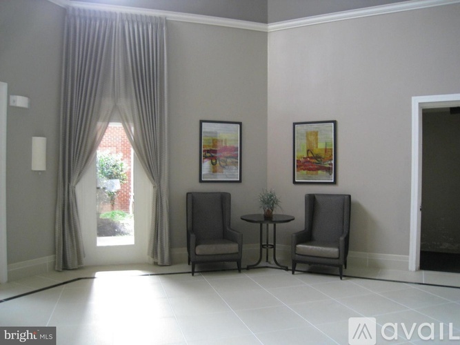 A bright room with two chairs and a small table.