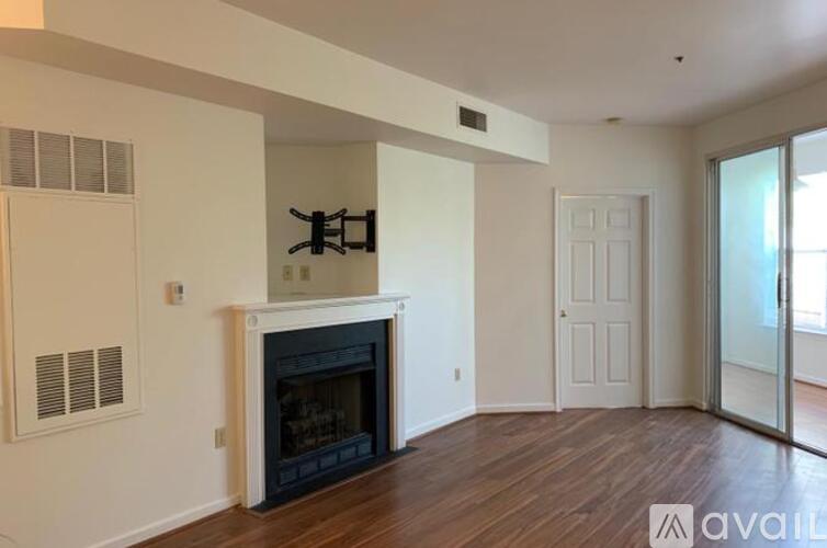 A living room with a fireplace and sliding glass doors.