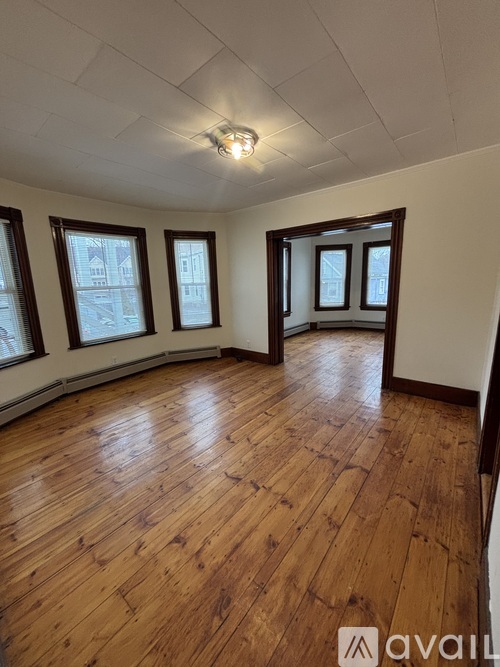 A room with wooden floors and windows.