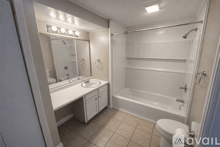 A white bathroom with a toilet, sink, and bathtub.