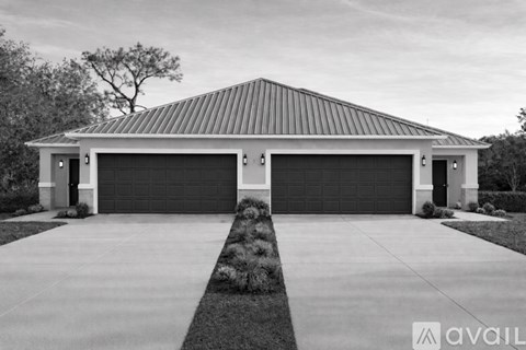 A two-car garage with a metal roof and a concrete driveway.