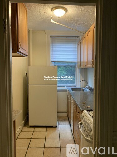 A kitchen with a white fridge and a white dishwasher.
