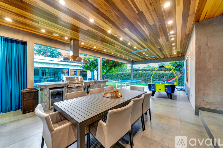 A modern dining room with a wooden table and chairs.