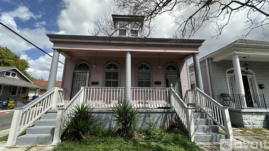 A house with a porch and a balcony.