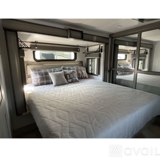 A bedroom with a large bed and a window.