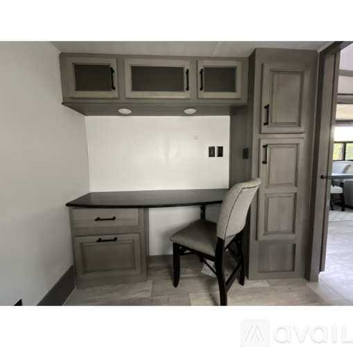A kitchen with a table and chairs and a cabinet above it.