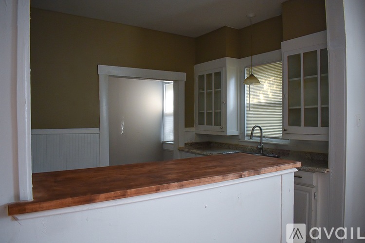 A kitchen with brown cabinets and a white counter.