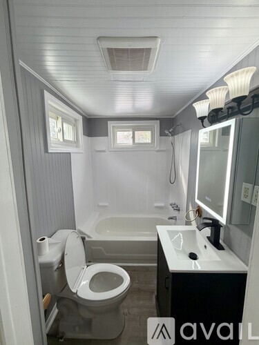A small bathroom with a toilet, sink, and bathtub.