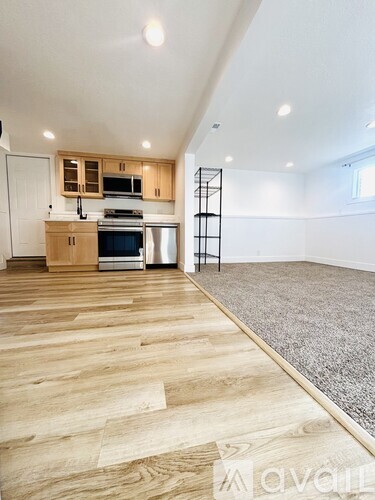 A kitchen with wooden floors and white walls.