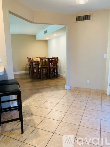 A dining room with a table and chairs.