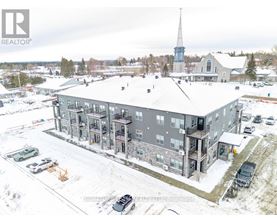A large grey building with a steeple in the background.