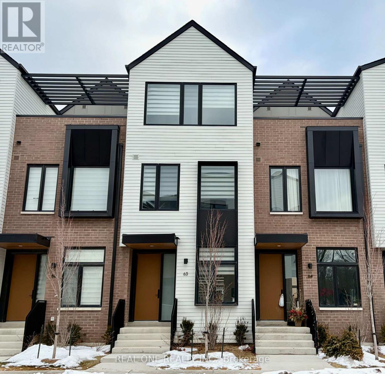 A modern two-story residential building with a mix of brick and siding exterior.