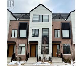 A modern two-story residential building with a mix of brick and siding exterior.