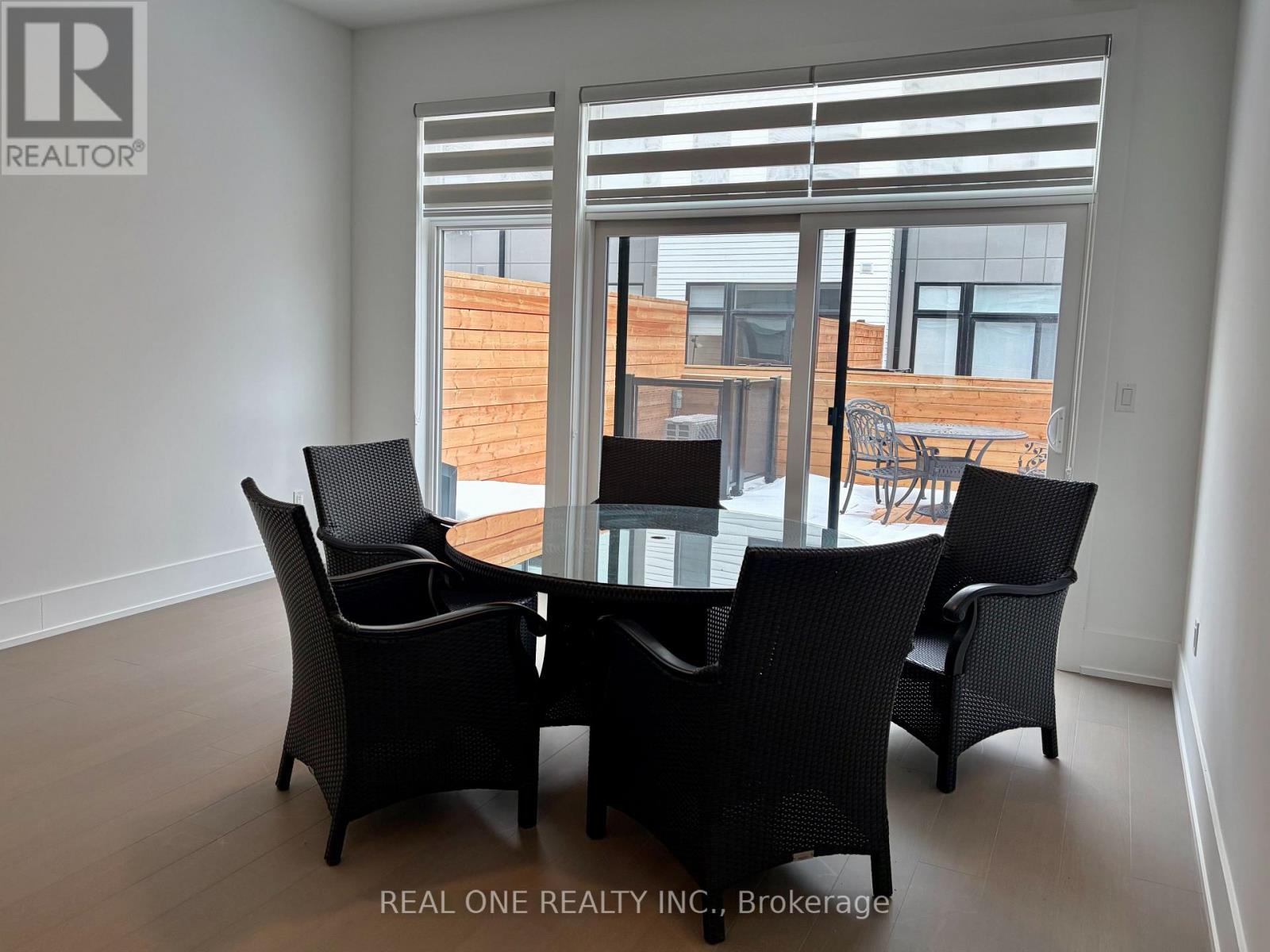 A dining room with a glass table and chairs.