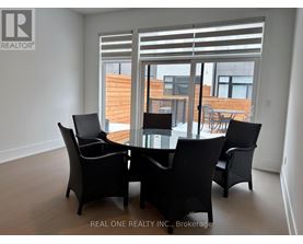 A dining room with a glass table and chairs.