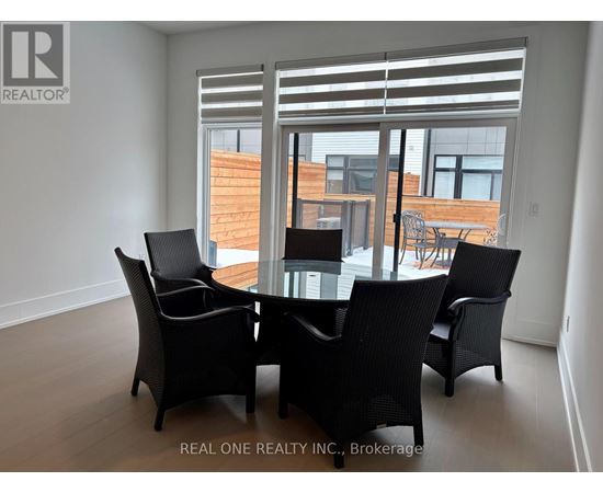 A dining room with a glass table and chairs.