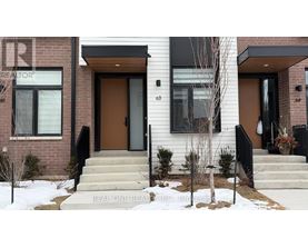 A house with a brown door and a sign that says "REAL ONE REALTOR".
