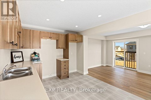 A kitchen with wooden cabinets and a sink.