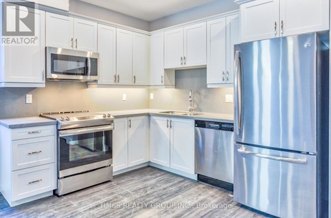 A kitchen with white cabinets and stainless steel appliances.