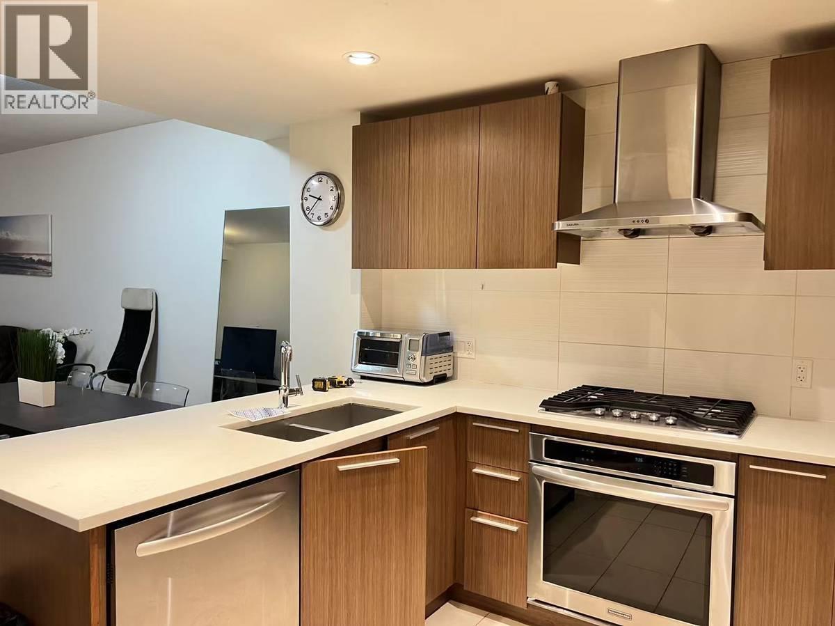 A modern kitchen with wooden cabinets and stainless steel appliances.