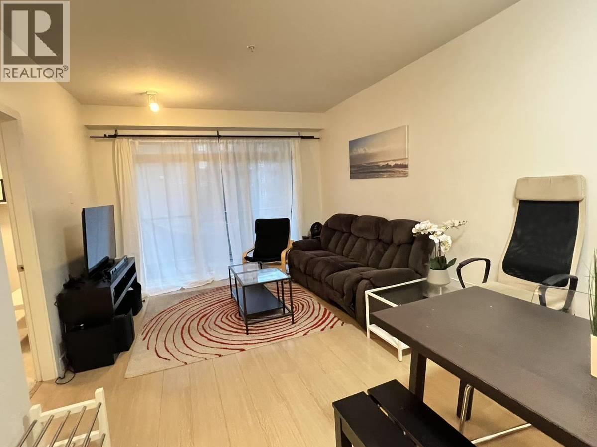 A living room with a brown couch, a television, and a coffee table.