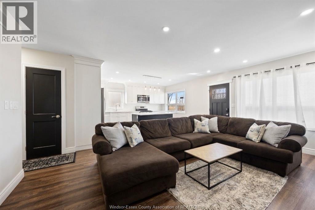 A living room with a brown couch and a coffee table.
