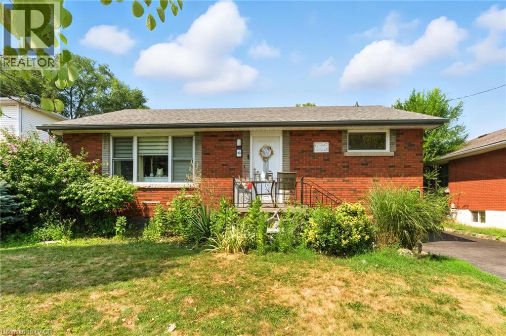 A red brick house with a white door and a small porch.