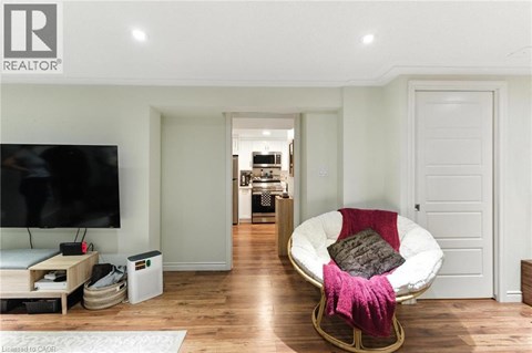 A modern living room with a white sofa and a television.